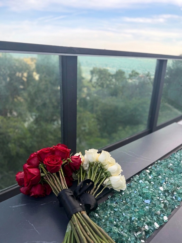 Red and white roses on balcony fire table